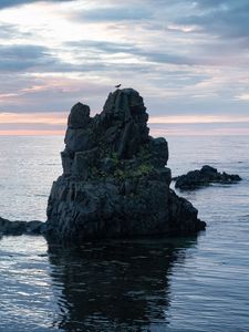 Preview wallpaper rock, sea, silhouette, nature, evening