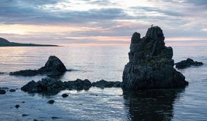 Preview wallpaper rock, sea, silhouette, nature, evening