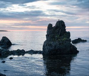 Preview wallpaper rock, sea, silhouette, nature, evening