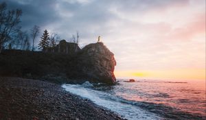 Preview wallpaper rock, sea, silhouette, coast, beach, stones