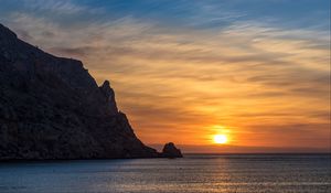Preview wallpaper rock, sea, sunset, horizon, dark