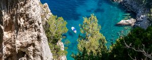 Preview wallpaper rock, sea, trees, boats, bottom