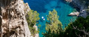 Preview wallpaper rock, sea, trees, boats, bottom