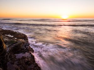 Preview wallpaper rock, sea, waves, sunset