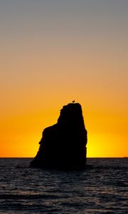 Preview wallpaper rock, silhouette, sea, sunset, horizon, landscape