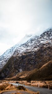 Preview wallpaper rock, slope, road, snow, snowy, fog