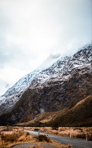 Preview wallpaper rock, slope, road, snow, snowy, fog