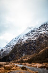 Preview wallpaper rock, slope, road, snow, snowy, fog