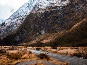 Preview wallpaper rock, slope, road, snow, snowy, fog
