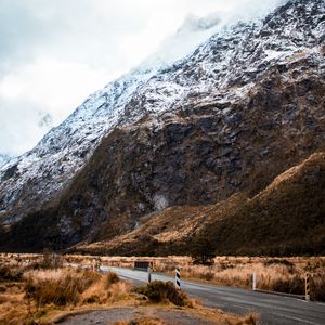 Preview wallpaper rock, slope, road, snow, snowy, fog