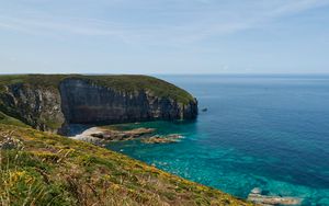 Preview wallpaper rock, slope, sea, grass, sky