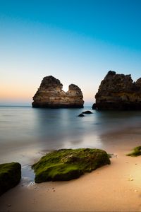 Preview wallpaper rock, stone, beach, sea, twilight