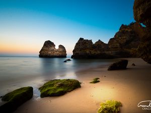 Preview wallpaper rock, stone, beach, sea, twilight