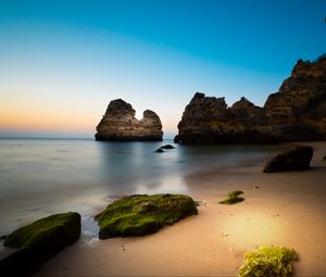 Preview wallpaper rock, stone, beach, sea, twilight