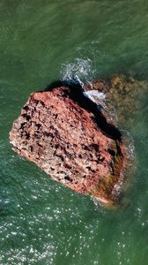 Preview wallpaper rock, stone, sea, glare, aerial view