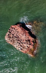 Preview wallpaper rock, stone, sea, glare, aerial view