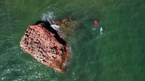 Preview wallpaper rock, stone, sea, glare, aerial view
