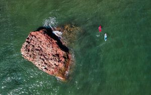 Preview wallpaper rock, stone, sea, glare, aerial view