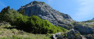 Preview wallpaper rock, stones, bushes, nature, sky, view from below, colorful