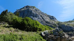 Preview wallpaper rock, stones, bushes, nature, sky, view from below, colorful