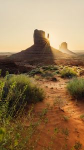 Preview wallpaper rock, valley, rays, sand, bushes