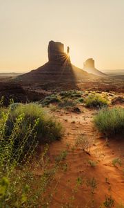 Preview wallpaper rock, valley, rays, sand, bushes