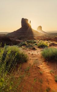 Preview wallpaper rock, valley, rays, sand, bushes