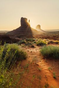 Preview wallpaper rock, valley, rays, sand, bushes