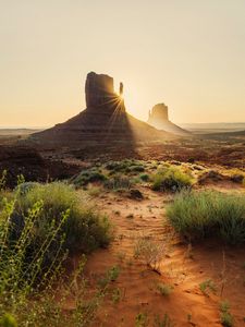 Preview wallpaper rock, valley, rays, sand, bushes