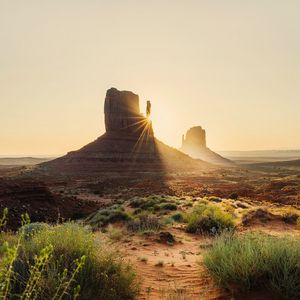 Preview wallpaper rock, valley, rays, sand, bushes
