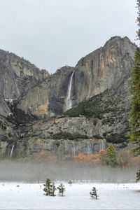 Preview wallpaper rock, waterfall, snow, trees, fog, nature