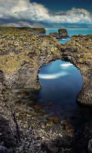 Preview wallpaper rocks, arch, reeves, pebble, stones, sea, coast, clouds, volume, hole
