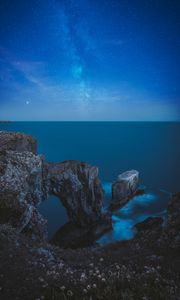 Preview wallpaper rocks, arch, sea, starry sky, horizon, night