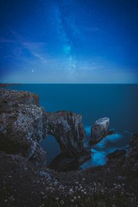 Preview wallpaper rocks, arch, sea, starry sky, horizon, night