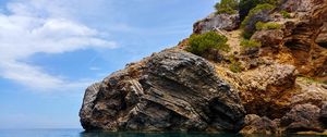 Preview wallpaper rocks, bushes, sea, cliff, sky