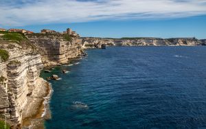 Preview wallpaper rocks, cliff, sea, buildings