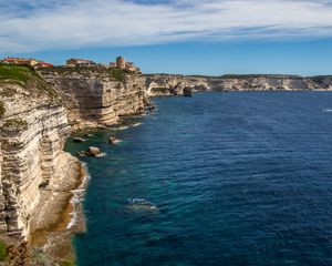 Preview wallpaper rocks, cliff, sea, buildings