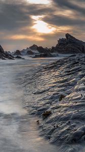 Preview wallpaper rocks, coast, water, sunset, landscape