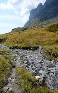 Preview wallpaper rocks, hill, grass, path, stones, nature