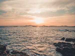 Preview wallpaper rocks, horizon, sea, sun