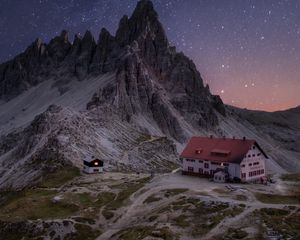 Preview wallpaper rocks, mountains, starry sky, house, night