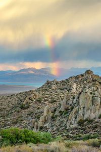 Preview wallpaper rocks, relief, clouds, rainbow, landscape