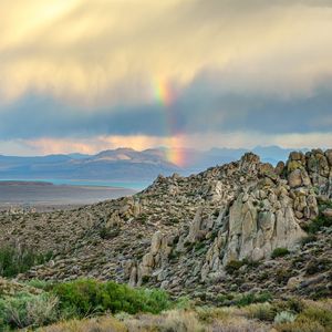 Preview wallpaper rocks, relief, clouds, rainbow, landscape