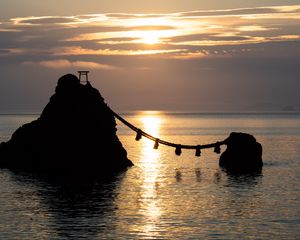Preview wallpaper rocks, rope, sea, sun, sunset, dark