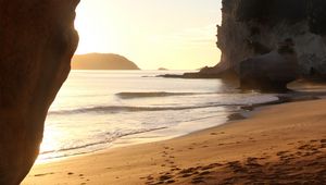 Preview wallpaper rocks, sand, footprints, sea, waves