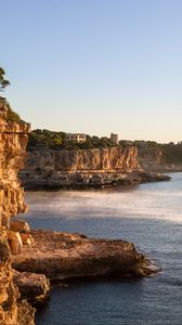 Preview wallpaper rocks, sea, cliff, buildings, landscape