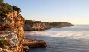 Preview wallpaper rocks, sea, cliff, buildings, landscape