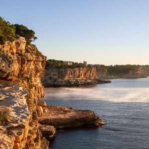 Preview wallpaper rocks, sea, cliff, buildings, landscape