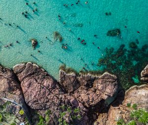 Preview wallpaper rocks, sea, coast, aerial view, people