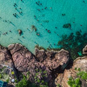 Preview wallpaper rocks, sea, coast, aerial view, people